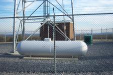 A view of the propane tank, generator, and equipment building for this unlabled tower.
