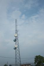 A microwave tower with four dishes.